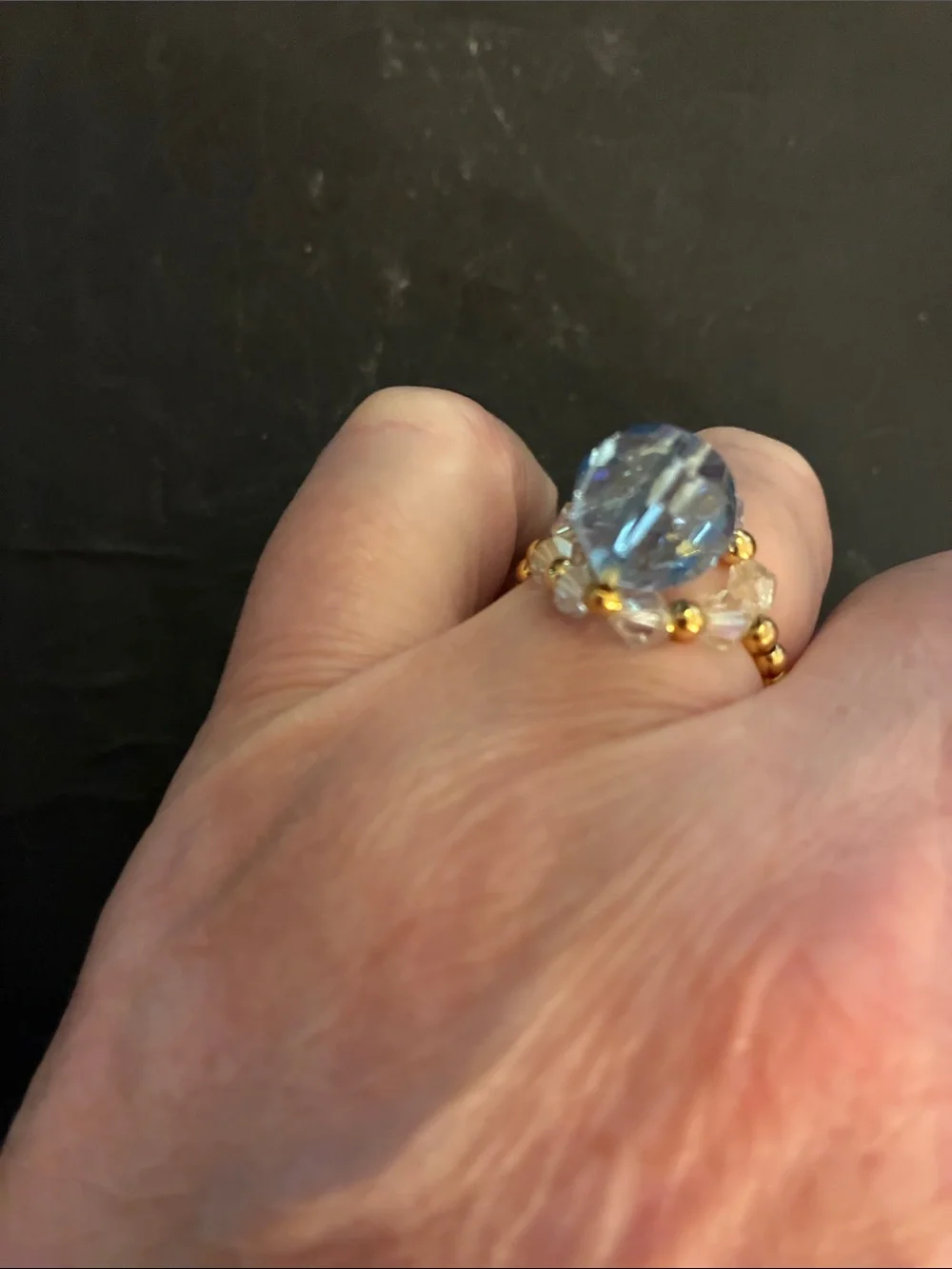 Gold-Tone Stretch Beads.Ring with Light Blue Faceted Stone and Crystal Accents.